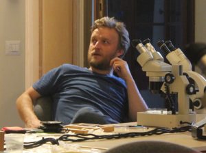 Man and microscope.